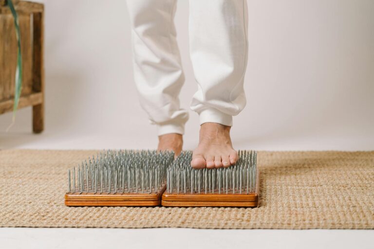 Foot close-up on a sadhu board for alternative healing and wellness practice.